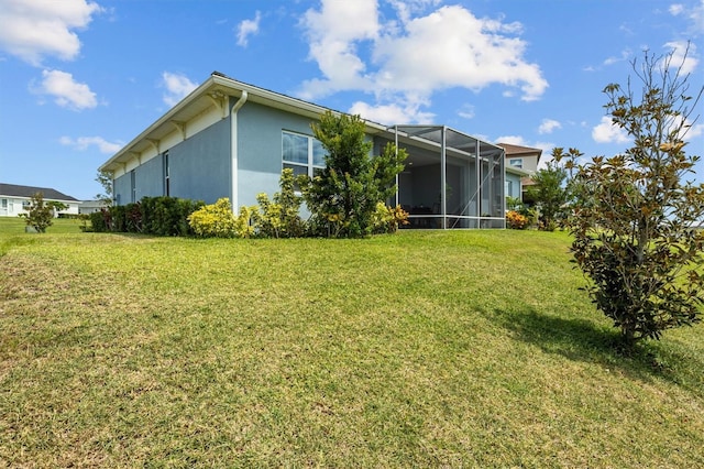 545 Pond Cypress Ct, Auburndale, FL 33823 - back of house with a lawn, stucco siding, and a lanai