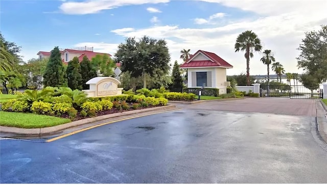 545 Pond Cypress Ct, Auburndale, FL 33823 - view of asphalt road with curbs and a gated entry