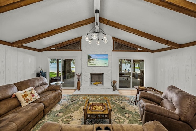 914 Mangham Rd, Babson Park, FL 33827 - living room featuring wood finished floors, wood walls, and a stone fireplace