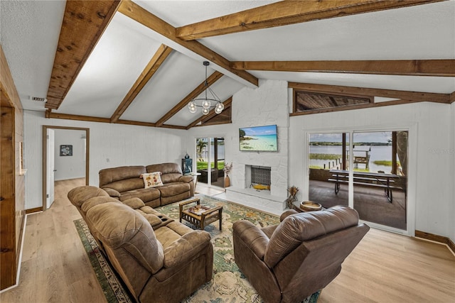 914 Mangham Rd, Babson Park, FL 33827 - living area featuring wood finished floors, a stone fireplace, and a chandelier