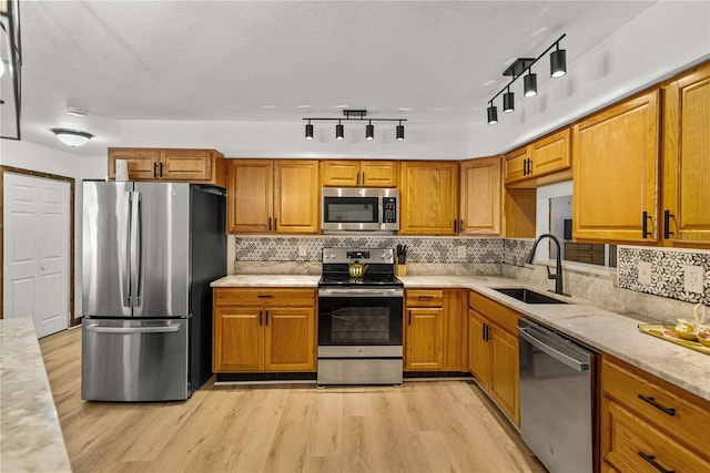 914 Mangham Rd, Babson Park, FL 33827 - kitchen featuring appliances with stainless steel finishes, light wood finished floors, backsplash, and brown cabinetry