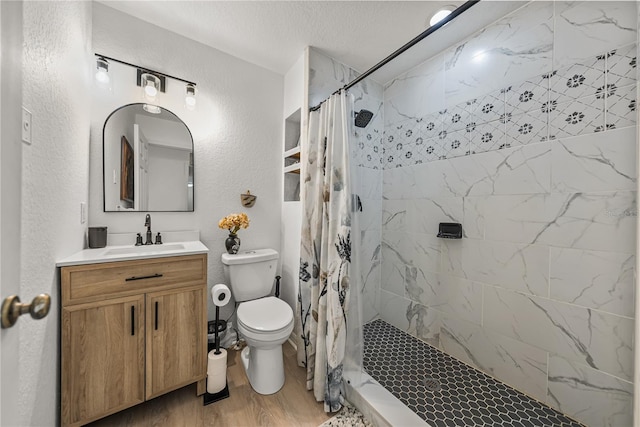 914 Mangham Rd, Babson Park, FL 33827 - full bath featuring vanity, tiled shower, wood finished floors, a textured wall, and a textured ceiling