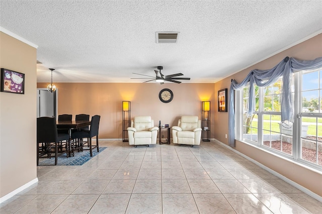 611 Caddy Dr, Kissimmee, FL 34759 - living area with ceiling fan, a textured ceiling, light tile patterned flooring, and ornamental molding