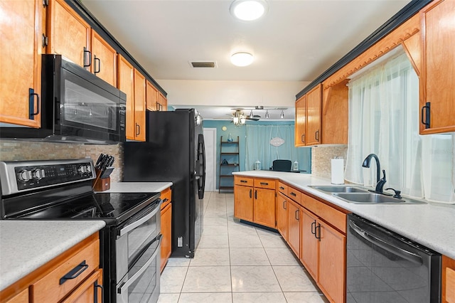 611 Caddy Dr, Kissimmee, FL 34759 - kitchen featuring black appliances, backsplash, light countertops, and brown cabinets