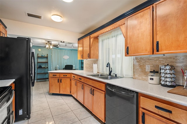 611 Caddy Dr, Kissimmee, FL 34759 - kitchen featuring black appliances, light countertops, decorative backsplash, light tile patterned flooring, and a peninsula