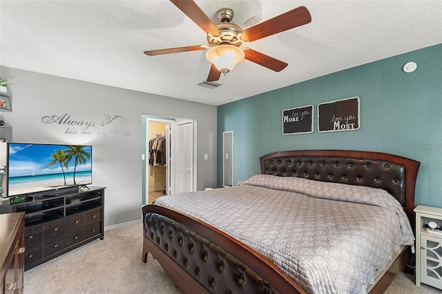 611 Caddy Dr, Kissimmee, FL 34759 - carpeted bedroom featuring a closet, a spacious closet, ceiling fan, and a textured ceiling