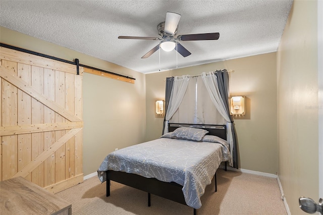 611 Caddy Dr, Kissimmee, FL 34759 - bedroom with carpet, a barn door, a textured ceiling, and a ceiling fan