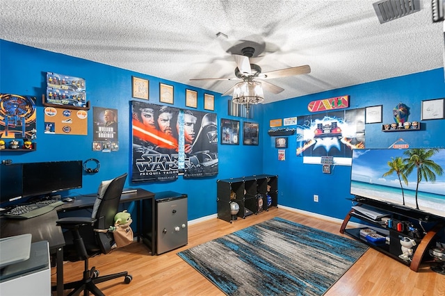 611 Caddy Dr, Kissimmee, FL 34759 - office area with a ceiling fan, wood finished floors, and a textured ceiling