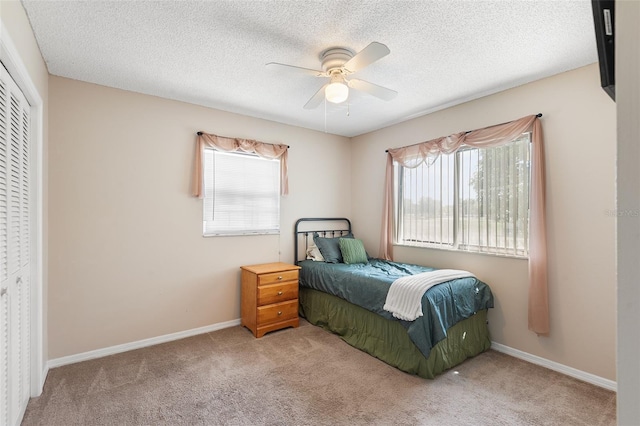 611 Caddy Dr, Kissimmee, FL 34759 - bedroom featuring carpet flooring, multiple windows, a closet, ceiling fan, and a textured ceiling