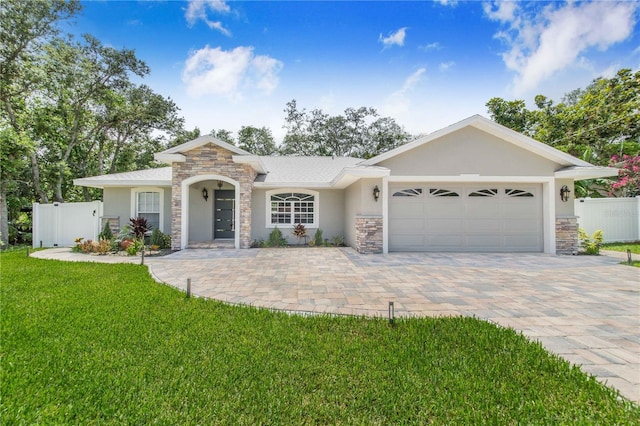 1823 N Olivia Dr, Avon Park, FL 33825 - ranch-style house featuring stone siding, stucco siding, an attached garage, and decorative driveway