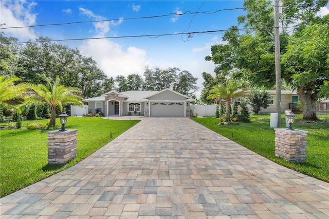 1823 N Olivia Dr, Avon Park, FL 33825 - ranch-style house featuring decorative driveway, a garage, and stone siding