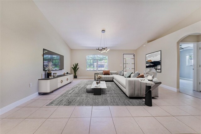1823 N Olivia Dr, Avon Park, FL 33825 - living room with lofted ceiling, light tile patterned flooring, arched walkways, and a chandelier