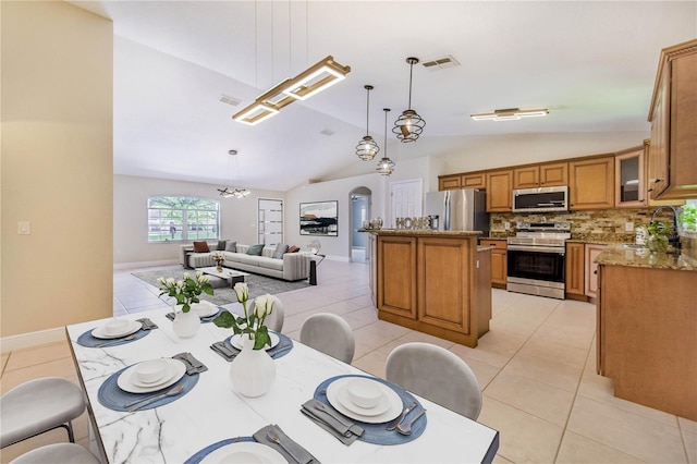1823 N Olivia Dr, Avon Park, FL 33825 - dining area with lofted ceiling, light tile patterned flooring, and a chandelier