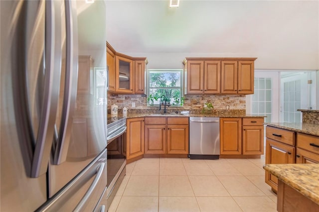 1823 N Olivia Dr, Avon Park, FL 33825 - kitchen featuring stainless steel appliances, decorative backsplash, light stone counters, and brown cabinets