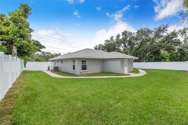 1823 N Olivia Dr, Avon Park, FL 33825 - back of house featuring a fenced backyard, stucco siding, and a shingled roof