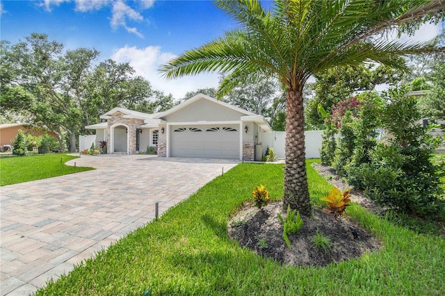 1823 N Olivia Dr, Avon Park, FL 33825 - view of front of home with stone siding, decorative driveway, an attached garage, and stucco siding