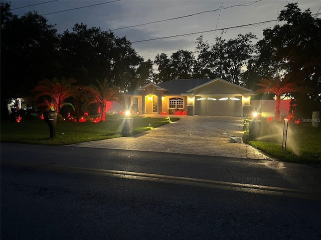 1823 N Olivia Dr, Avon Park, FL 33825 - view of front facade featuring a garage, driveway, and a front yard