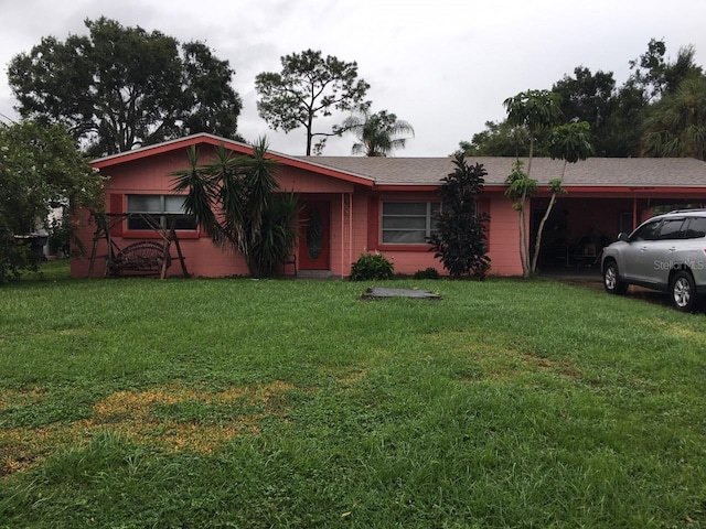 1811 5th St SE, Winter Haven, FL 33880 - single story home with concrete block siding, a front yard, and an attached carport