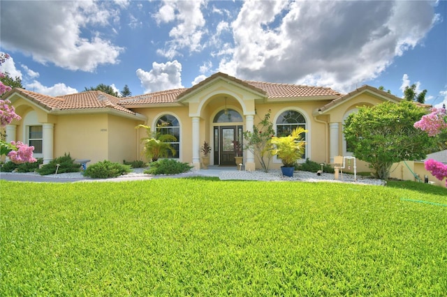 10708 Belo Horizonte Ave, Clermont, FL 34711 - mediterranean / spanish-style house featuring a front yard, stucco siding, and a tiled roof