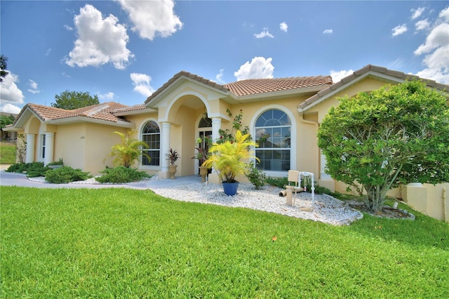 10708 Belo Horizonte Ave, Clermont, FL 34711 - mediterranean / spanish-style house featuring a front lawn, stucco siding, and a tiled roof