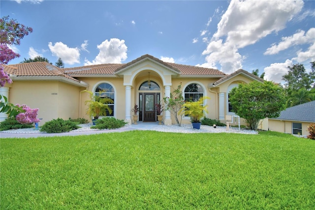 10708 Belo Horizonte Ave, Clermont, FL 34711 - mediterranean / spanish home featuring a front lawn, stucco siding, and a tiled roof