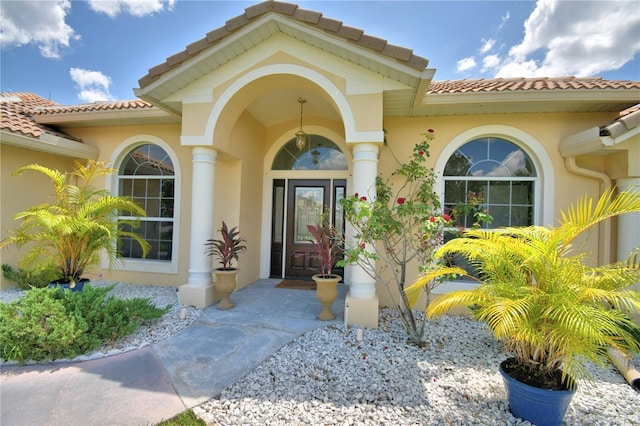 10708 Belo Horizonte Ave, Clermont, FL 34711 - view of exterior entry featuring a tile roof and stucco siding