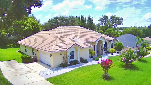 10708 Belo Horizonte Ave, Clermont, FL 34711 - view of front of home with stucco siding, a tiled roof, concrete driveway, a front lawn, and a garage