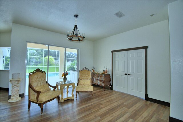 10708 Belo Horizonte Ave, Clermont, FL 34711 - living area with wood finished floors and a chandelier