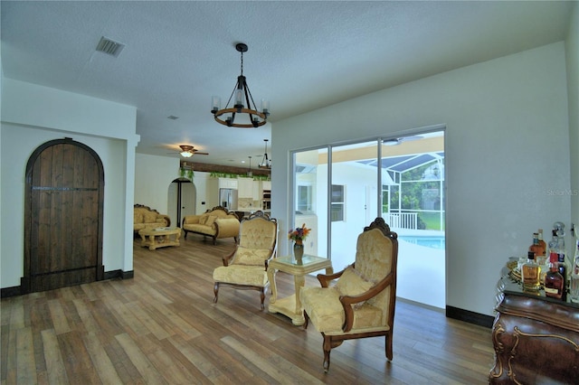 10708 Belo Horizonte Ave, Clermont, FL 34711 - living area featuring wood finished floors, a chandelier, and ceiling fan