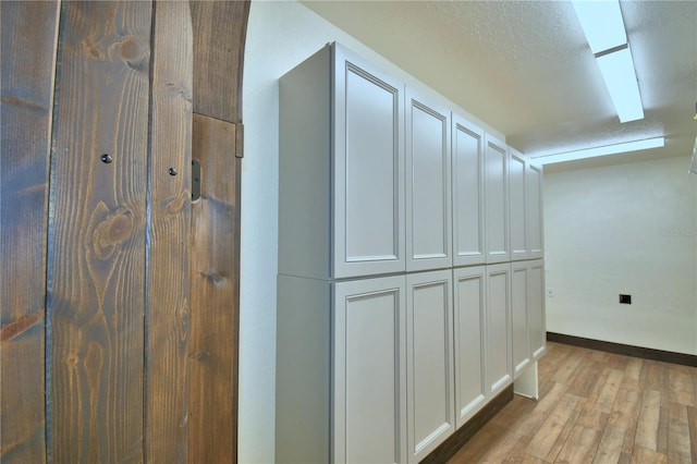 10708 Belo Horizonte Ave, Clermont, FL 34711 - corridor featuring light wood-type flooring and baseboards