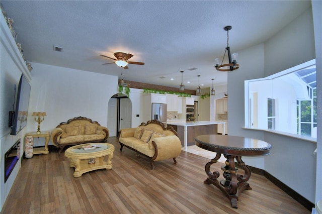 10708 Belo Horizonte Ave, Clermont, FL 34711 - living room with wood finished floors, ceiling fan, and a textured ceiling