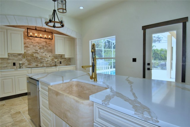 10708 Belo Horizonte Ave, Clermont, FL 34711 - kitchen featuring a chandelier, light stone countertops, tasteful backsplash, decorative light fixtures, and black electric cooktop