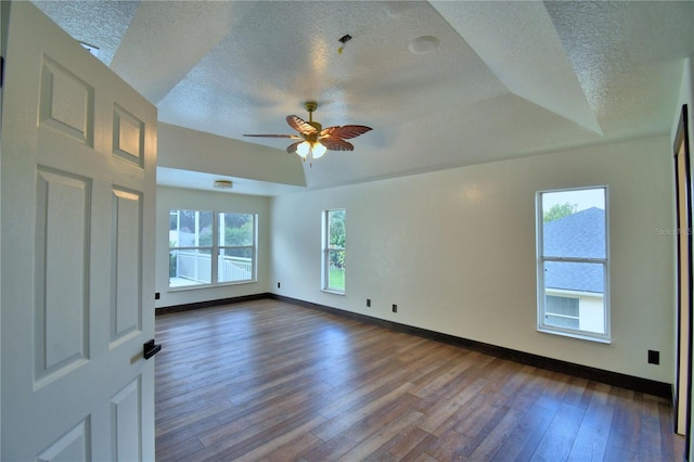 10708 Belo Horizonte Ave, Clermont, FL 34711 - unfurnished room featuring a textured ceiling, dark wood-style floors, plenty of natural light, and a ceiling fan