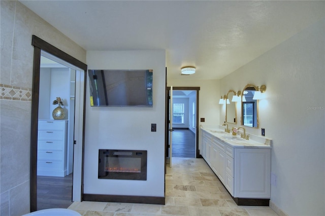 10708 Belo Horizonte Ave, Clermont, FL 34711 - bathroom with double vanity and a glass covered fireplace