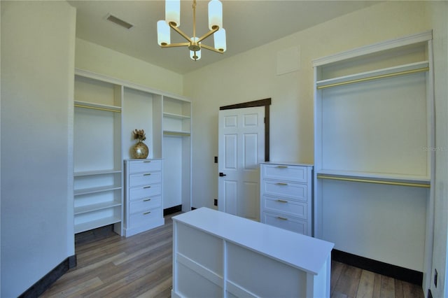 10708 Belo Horizonte Ave, Clermont, FL 34711 - walk in closet with a chandelier and dark wood-type flooring