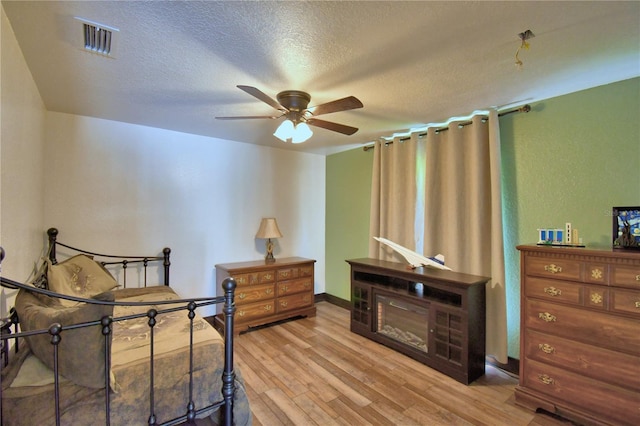 10708 Belo Horizonte Ave, Clermont, FL 34711 - bedroom with light wood-style flooring and a textured ceiling