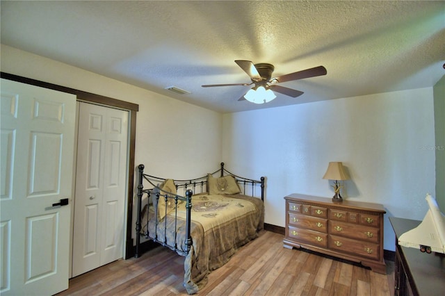 10708 Belo Horizonte Ave, Clermont, FL 34711 - bedroom featuring wood finished floors, a closet, ceiling fan, and a textured ceiling
