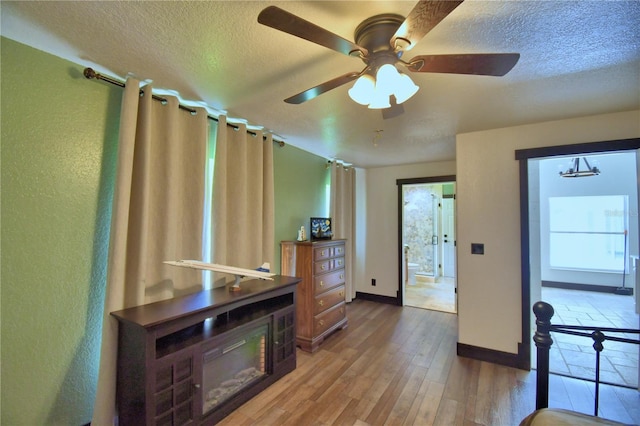 10708 Belo Horizonte Ave, Clermont, FL 34711 - living room featuring a textured ceiling, a ceiling fan, wood finished floors, and a textured wall