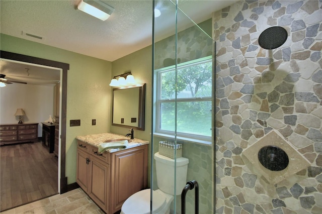 10708 Belo Horizonte Ave, Clermont, FL 34711 - bathroom featuring a textured ceiling, vanity, a shower, and ceiling fan