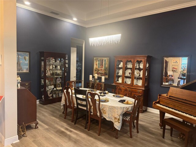 25863 Crossings Bluff Ln, Sorrento, FL 32776 - dining room featuring a towering ceiling, wood finished floors, and ornamental molding
