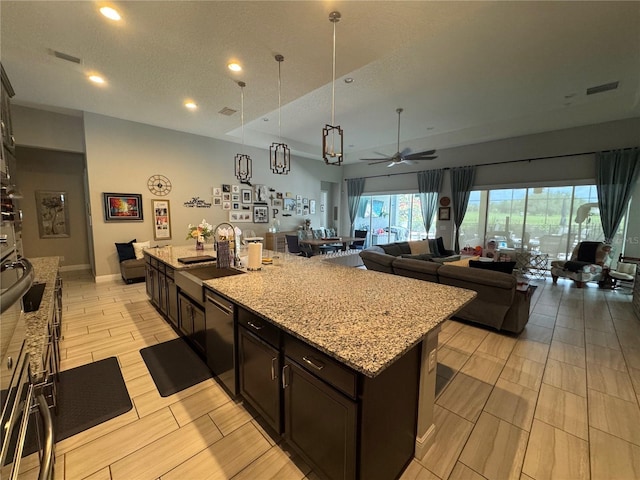 25863 Crossings Bluff Ln, Sorrento, FL 32776 - kitchen featuring black dishwasher, open floor plan, a ceiling fan, light stone countertops, and recessed lighting