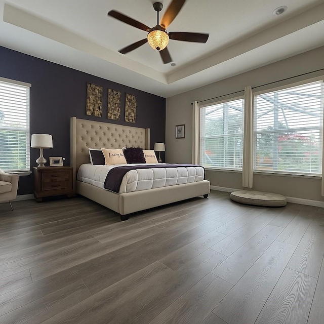25863 Crossings Bluff Ln, Sorrento, FL 32776 - bedroom featuring wood finished floors, a tray ceiling, and ceiling fan