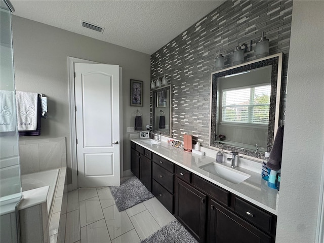 25863 Crossings Bluff Ln, Sorrento, FL 32776 - full bath featuring double vanity, a garden tub, and a textured ceiling