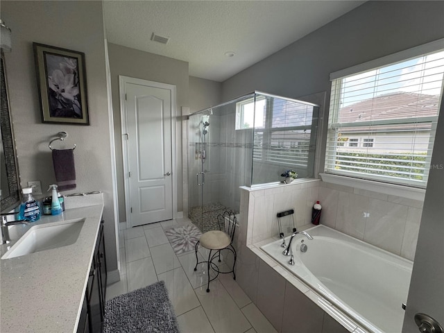 25863 Crossings Bluff Ln, Sorrento, FL 32776 - full bath with a stall shower, a bath, double vanity, and a textured ceiling