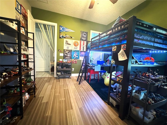 25863 Crossings Bluff Ln, Sorrento, FL 32776 - bedroom featuring wood finished floors, a textured ceiling, and ceiling fan