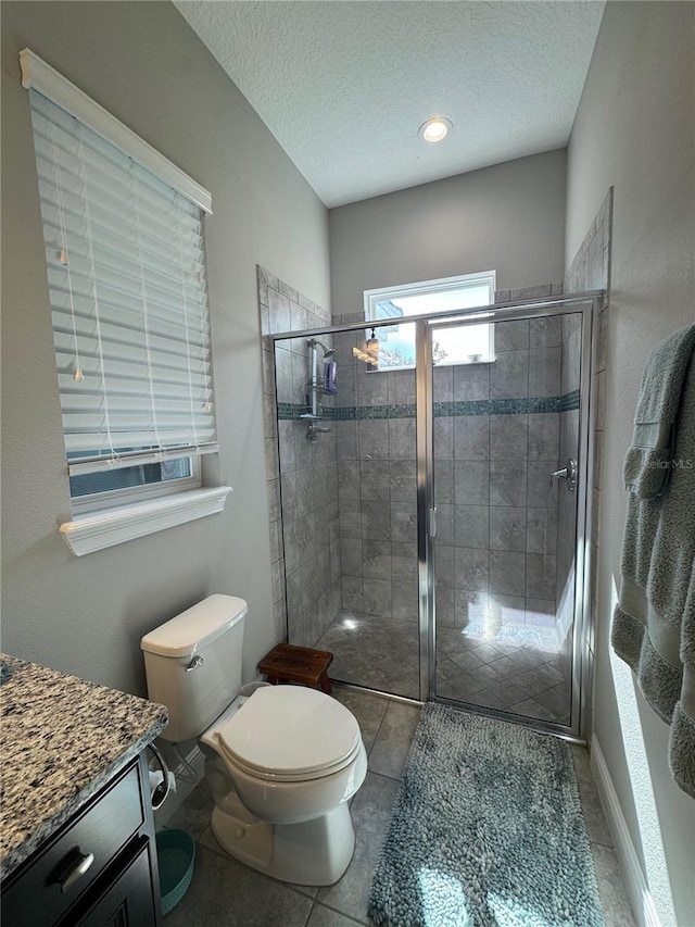 25863 Crossings Bluff Ln, Sorrento, FL 32776 - bathroom featuring a stall shower, a textured ceiling, tile patterned flooring, and vanity