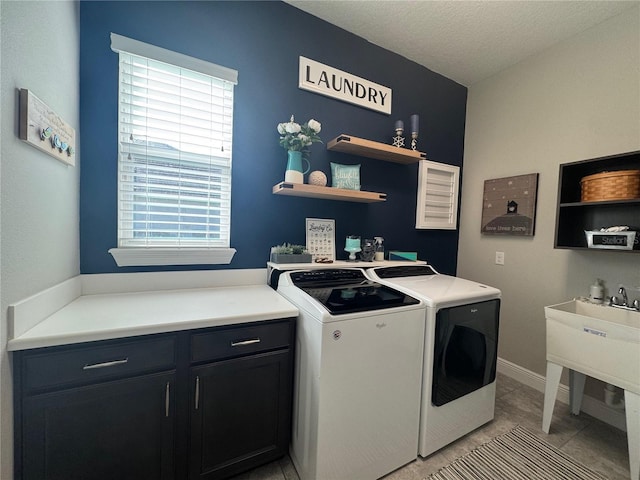 25863 Crossings Bluff Ln, Sorrento, FL 32776 - laundry area featuring cabinet space, washing machine and dryer, a textured ceiling, and light tile patterned floors