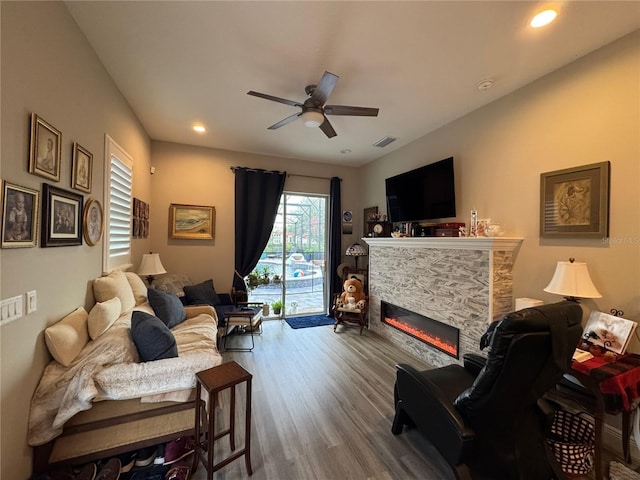 25863 Crossings Bluff Ln, Sorrento, FL 32776 - living area with ceiling fan, wood finished floors, a fireplace, and recessed lighting