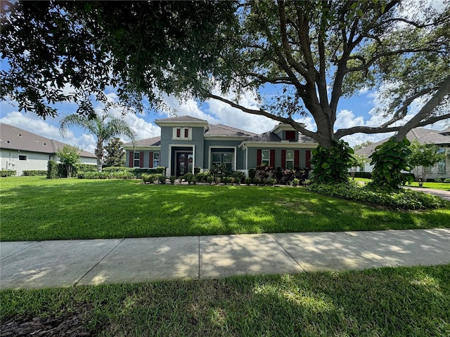 25863 Crossings Bluff Ln, Sorrento, FL 32776 - view of front facade featuring a front lawn and stucco siding