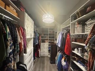 25863 Crossings Bluff Ln, Sorrento, FL 32776 - spacious closet featuring wood finished floors and a chandelier